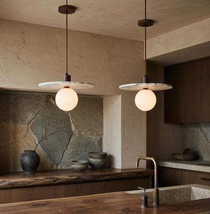 Deux suspensions marbre Wabi-Sabi dans une cusine mur en pierre naturelle, ambiance zen Japandi